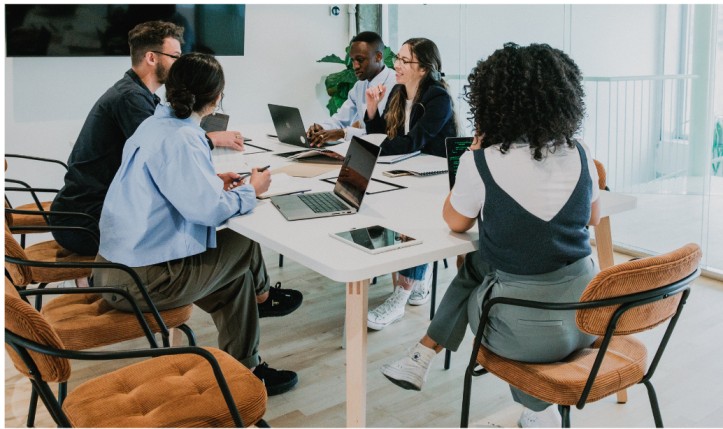 Room of business people talking around a table