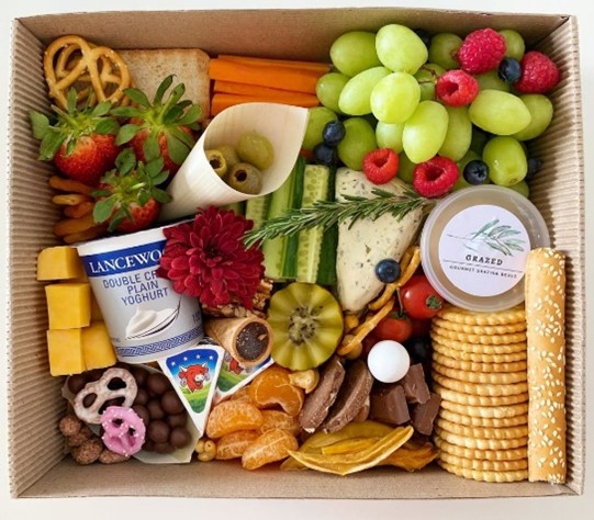 Graze box filled with grapes, olives, pretzels, crackers, cheeses and more! 