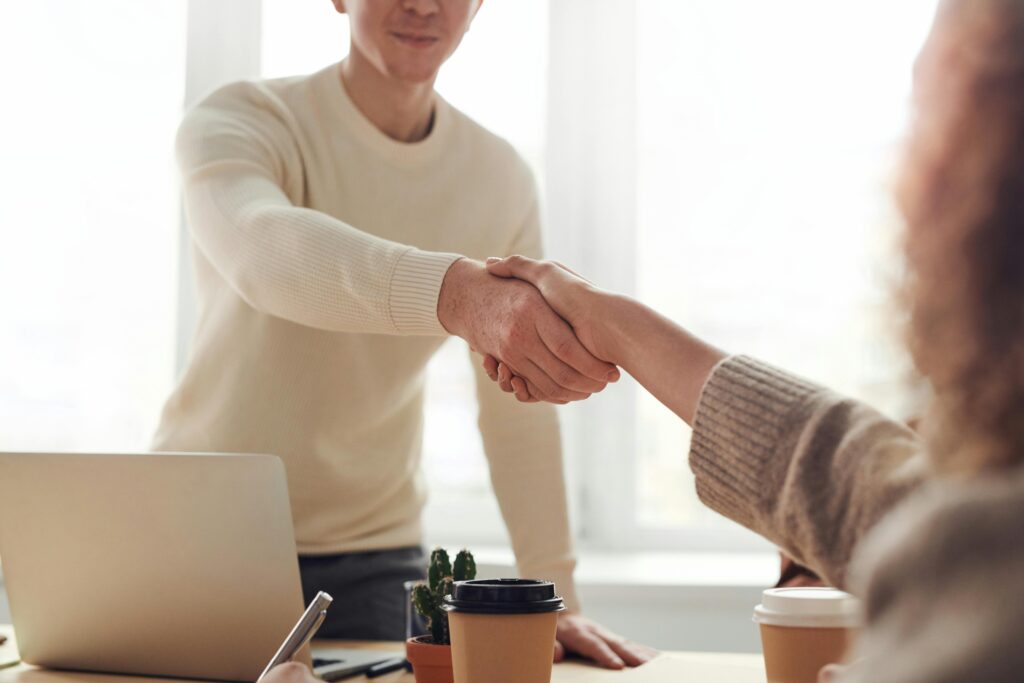 Two people shaking hands at an agreement